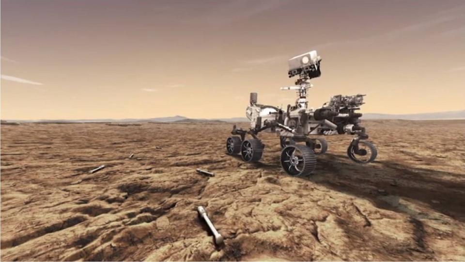 wheeled rover with camera on neck-like appendage drives across non-reddish-orange planet