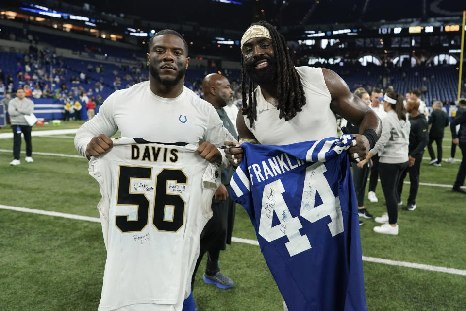 Indianapolis Colts linebacker Zaire Franklin, left, and New Orleans Saints linebacker Demario Davis, right, exchange jerseys after an NFL football game Sunday, Oct. 29, 2023 in Indianapolis. (AP Photo/Darron Cummings)