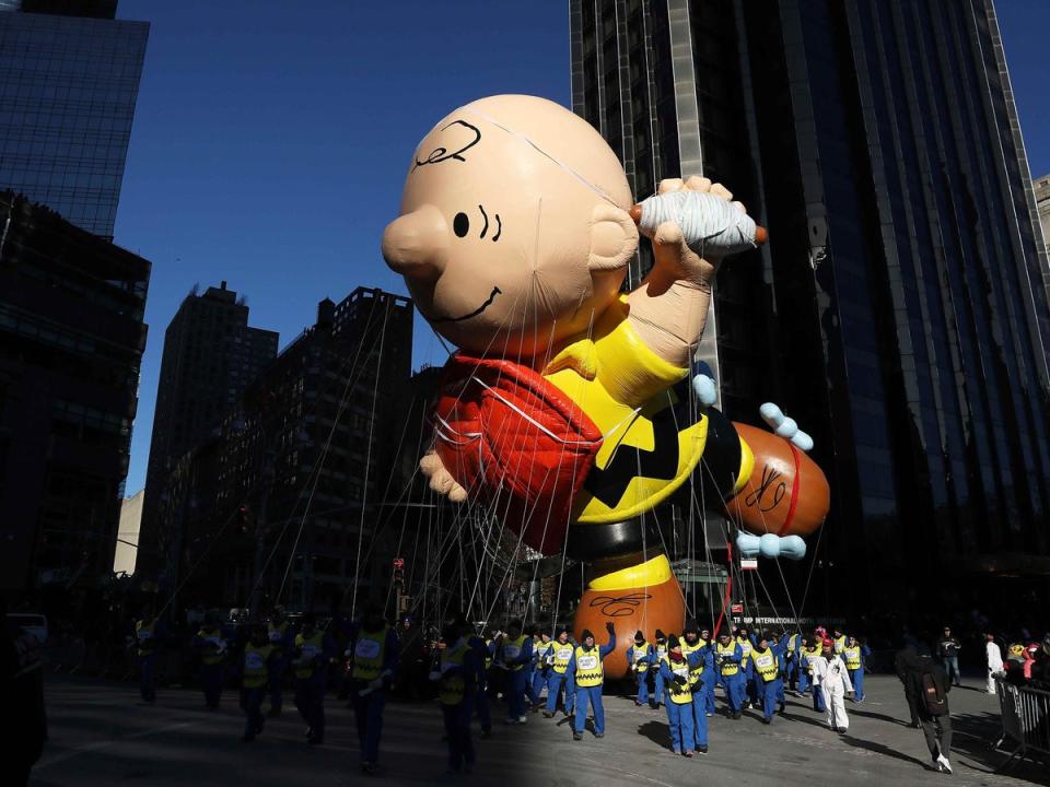 The Charlie Brown balloon flies in the parade (Reuters)