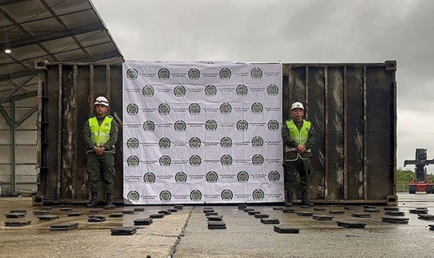 Authorities in an unspecified part of Colombia pose with seized cocaine, according to the RCMP.