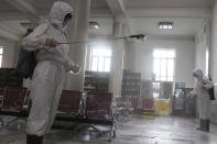Women in protective suits disinfect a hall at the Pyongyang Railway Station to help curb the spread of the coronavirus in Pyongyang, North Korea, Thursday, Aug. 13, 2020. (AP Photo/Jon Chol Jin)
