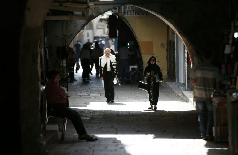 Al-Wad street in the Muslim quarter of Jerusalem's Old City is home to Palestinian shopkeepers and residents as well as Israeli settlers and Jewish students, who study at seminaries known as yeshivas near the Al-Aqsa mosque