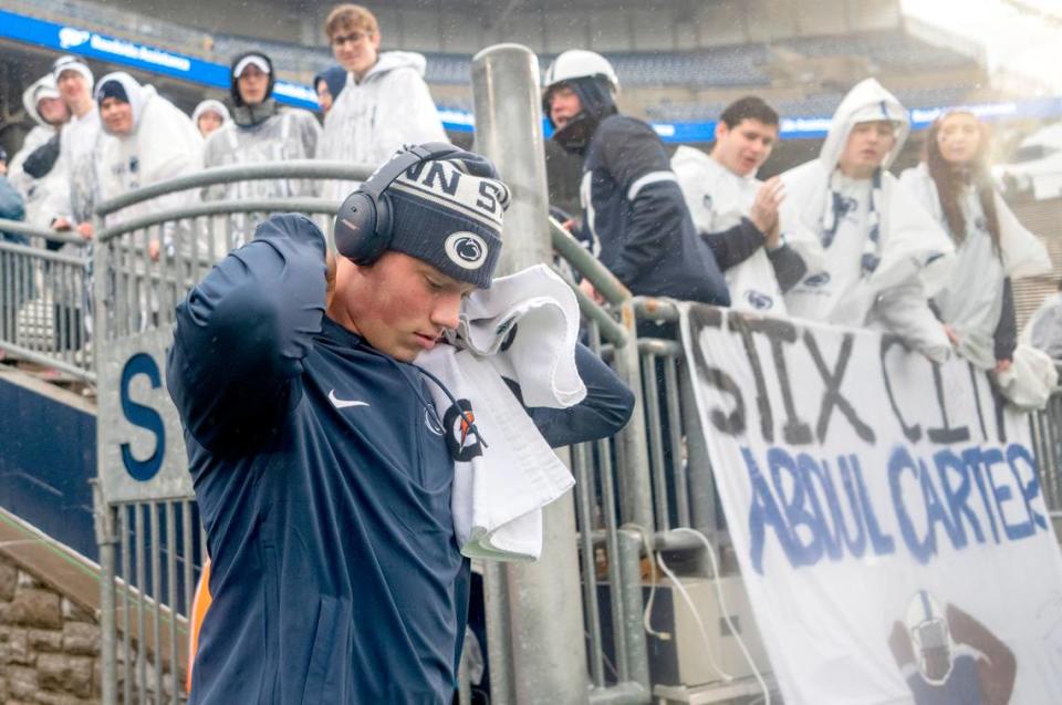Penn State quarterback Drew Allar pulls his hood up as he walks onto the field for warm-ups for the game against UMass on Saturday, Oct. 14, 2023.