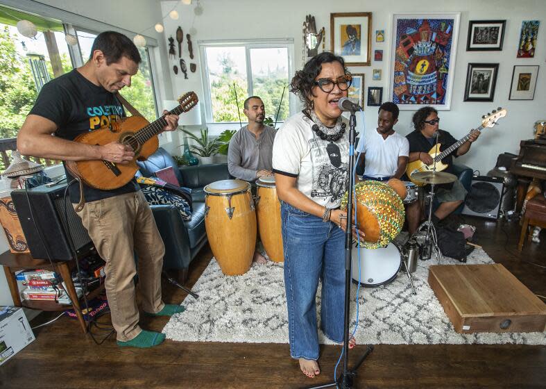 LOS ANGELES, CA-JULY 26, 2023: left to right-Quetzal Flores, Alberto Lopez, Dr. Martha Gonzalez, Evan Greer, and Juan Perez, members of the band Quetzal, rehearse in Los Angeles. The Grammy-winning East L.A. band has been one of the most innovative Chicano rock groups of the last three decades, fusing rock, R&B and regional Mexican music into a style that is alternately poetic and defiant. They're being honored with a 30th anniversary concert on August 19 at la Plaza de Cultural y Artes in downtown Los Angeles. (Mel Melcon / Los Angeles Times)