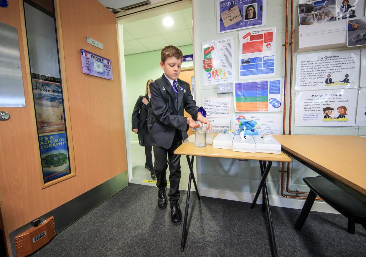 A pupil uses hand sanitizer has he enters a classroom at Outwood Academy Adwick in Doncaster, as schools in England reopen to pupils following the coronavirus lockdown on Wednesday, Sept. 2, 2020. Millions of children are returning to school across Europe and beyond in a mass experiment aimed at bridging inequalities and resuscitating economies despite the persistent pandemic. Governments are trying to show that life goes on despite a virus that has infected at least 25 million people worldwide and killed more than 850,000.