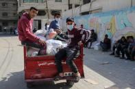 Palestinians receive food supplies at UNRWA distribution center in Gaza