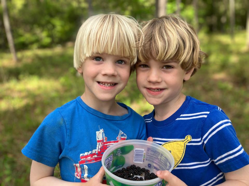 Fraternal twins James and Matthias Gardner pose in their backyard.