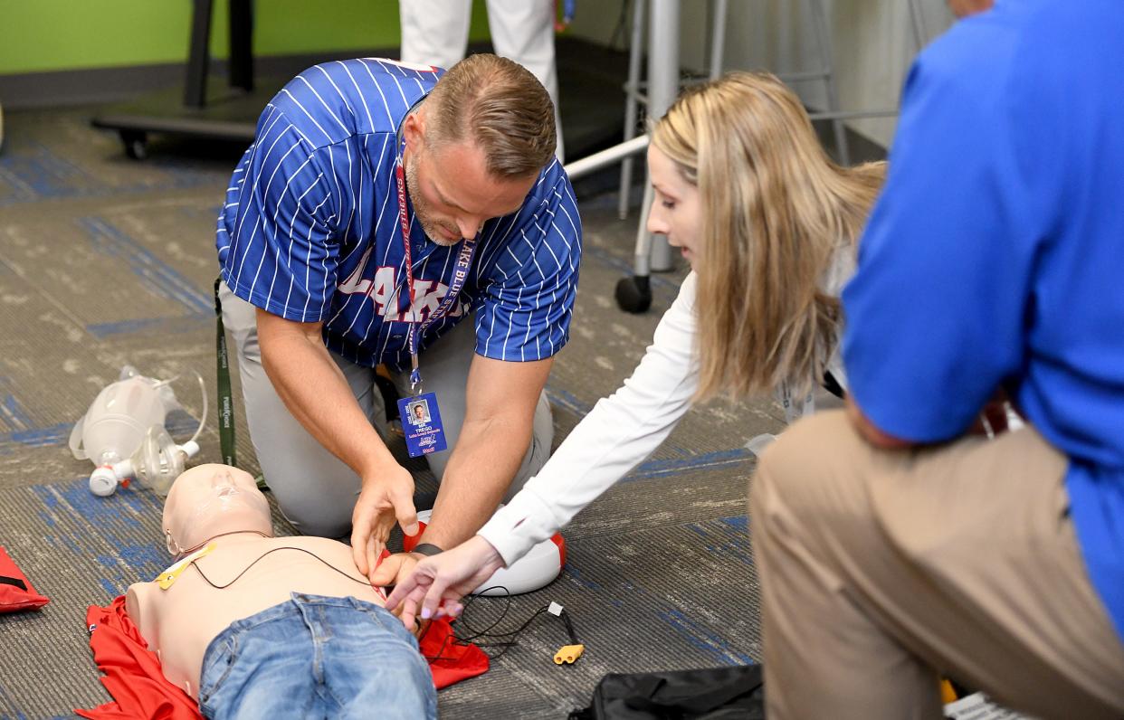 Lake High School health teacher Joe Trego and school nurse Catharine Hoover tend to a mannequin during a sudden cardiac arrest drill at Lake Middle/High School. The Lake Local School District is seeking to become the first Stark County school district to have all of its schools designated as heart safe schools through Project ADAM.