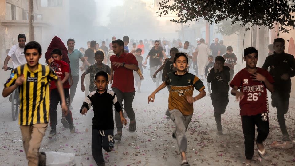 Palestinian children run as they flee from Israeli bombardment in Rafah, in southern Gaza, on November 6, 2023. - Mohammed Abed/AFP/Getty Images