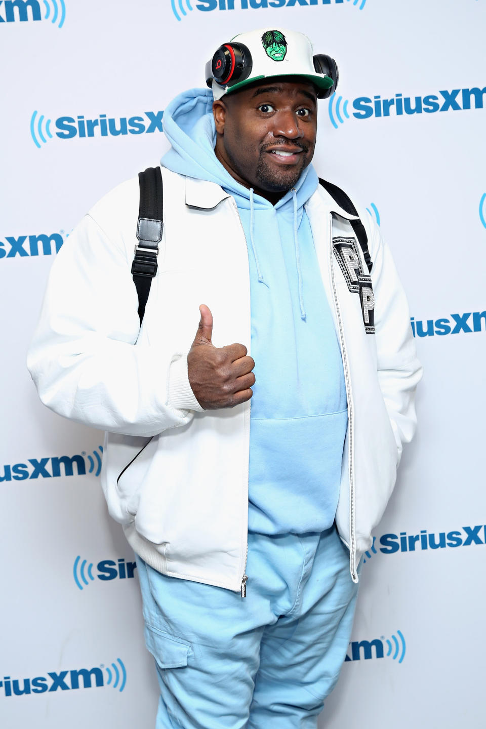 Corey Holcomb Wearing White Jacket And Blue Hoodie