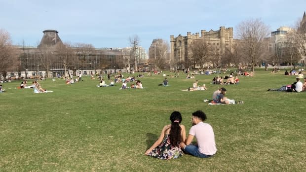 People sit in Ottawa's Major's Hill Park April 10, 2021, the first weekend under that provincewide stay-at-home order. You should not gather with friends outdoors during the stay-at-home order, says the province. (Rémi Authier/Radio-Canada - image credit)