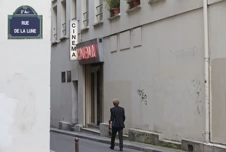 A man walks past the entrance of Le Beverley adult cinema in Paris July 30, 2014. REUTERS/Christian Hartmann