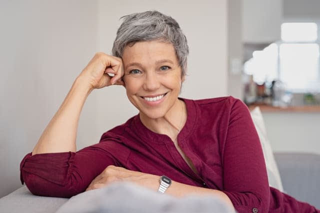 Happy senior woman on couch