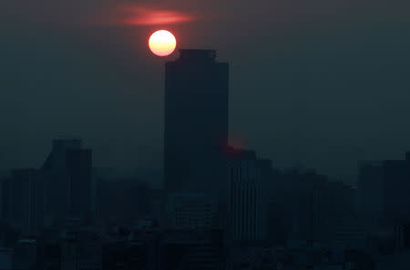 A general view shows buildings during high levels of pollution in Mexico City, Mexico May 14, 2019. Picture taken through a glass window. REUTERS/Henry Romero