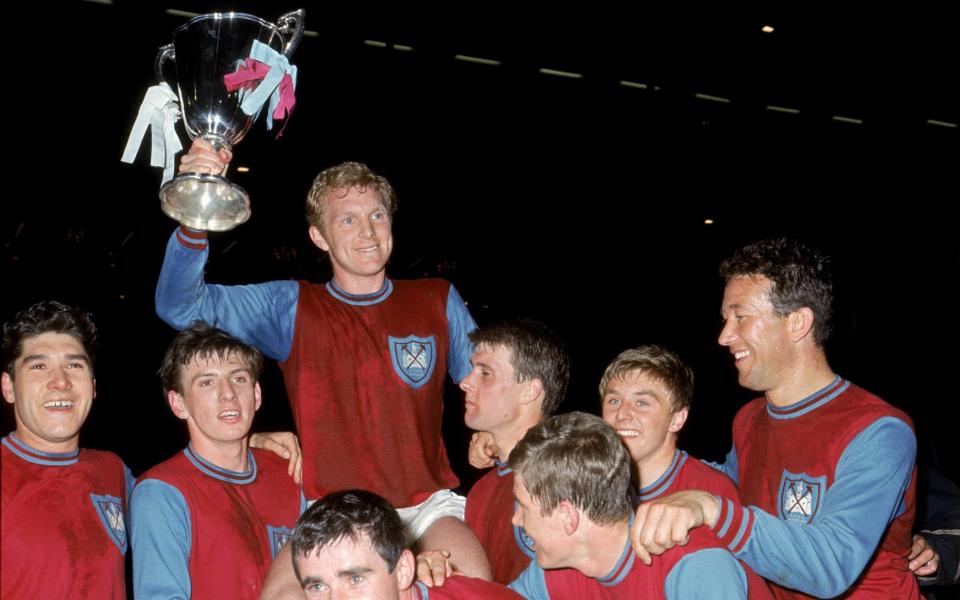 Bobby Moore, surrounded by his West Ham team-mates, holds up the European Cup Winners' Cup in 1965 - Brian Dear interview: ‘We were mainly from Barking, Dagenham, East Ham’ – West Ham’s European win - PA
