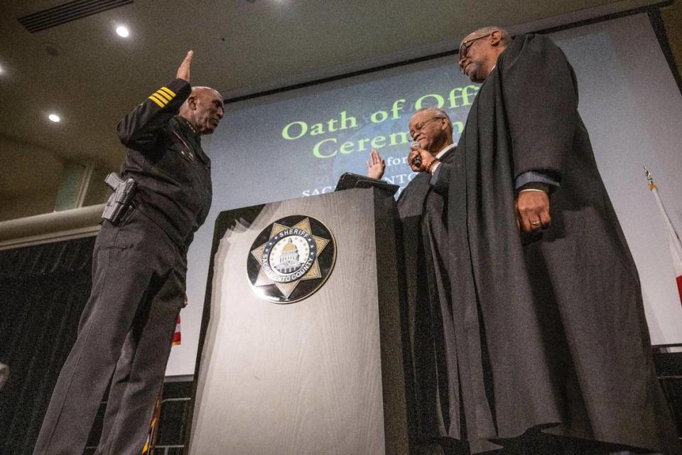 Newly elected Sacramento County Sheriff Jim Cooper takes the oath at a swearing-in ceremony at Sacramento State on Friday, Dec. 16, 2022. The oath was administered by federal judges Morison England and Troy Nunley.