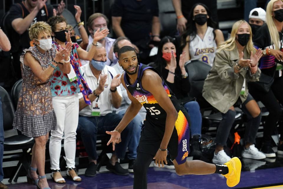 Phoenix Suns forward Mikal Bridges celebrates his three-point basket against the Los Angeles Lakers during the first half of Game 1 of their NBA basketball first-round playoff series Sunday, May 23, 2021, in Phoenix. (AP Photo/Ross D. Franklin)