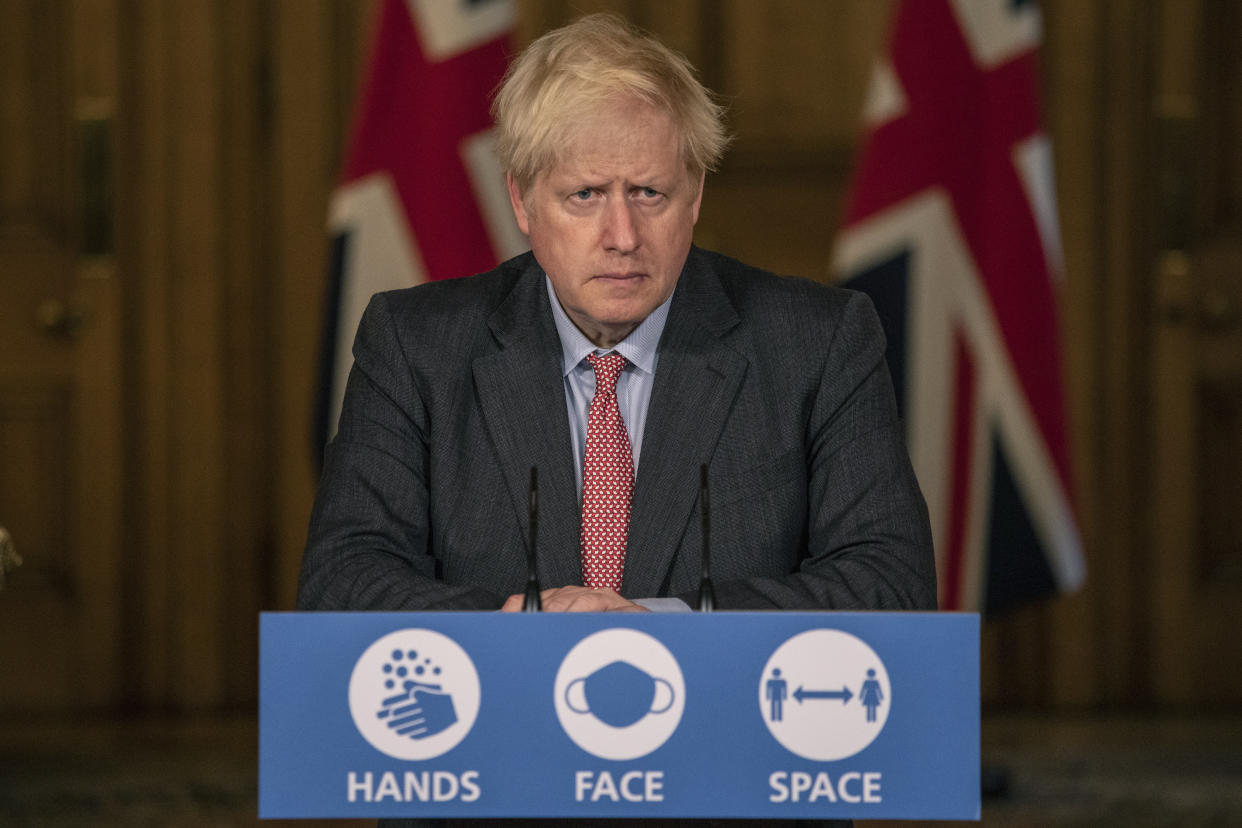 Britain's Prime Minister Boris Johnson listens, during a coronavirus briefing in Downing Street, London,  Wednesday, Sept. 30, 2020.  The number of new hospitalizations for COVID-19 and virus deaths in Britain are rising again, although both remain far below their springtime peak. (Jack Hill/Pool Photo via AP)