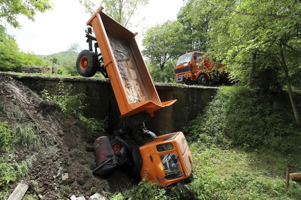 A truck used as barricade and cleared by Kosovo police lies off the road near Zubin Potok, northern Kosovo, Tuesday, May 28, 2019. Serbia put its troops on full alert Tuesday after heavily armed Kosovo police entered Serb-dominated northern Kosovo, firing tear gas and arresting nearly two dozen people. (AP Photo/Bojan Slavkovic)