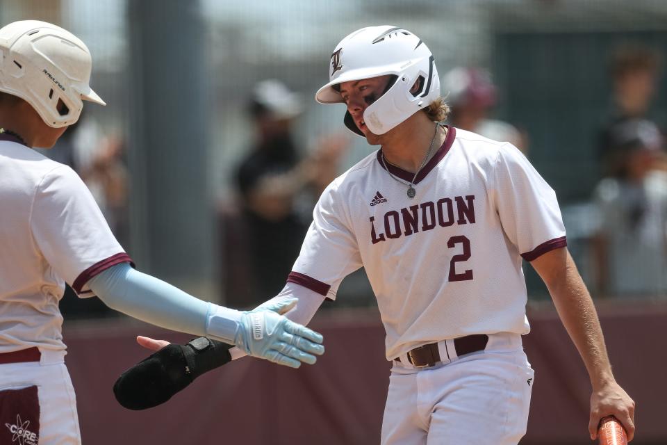 London’s Mason Jacob high-fives Christian Olivares during the Region IV-3A final series at Calallen High School on Saturday, June 3, 2023, in Corpus Christi, Texas.