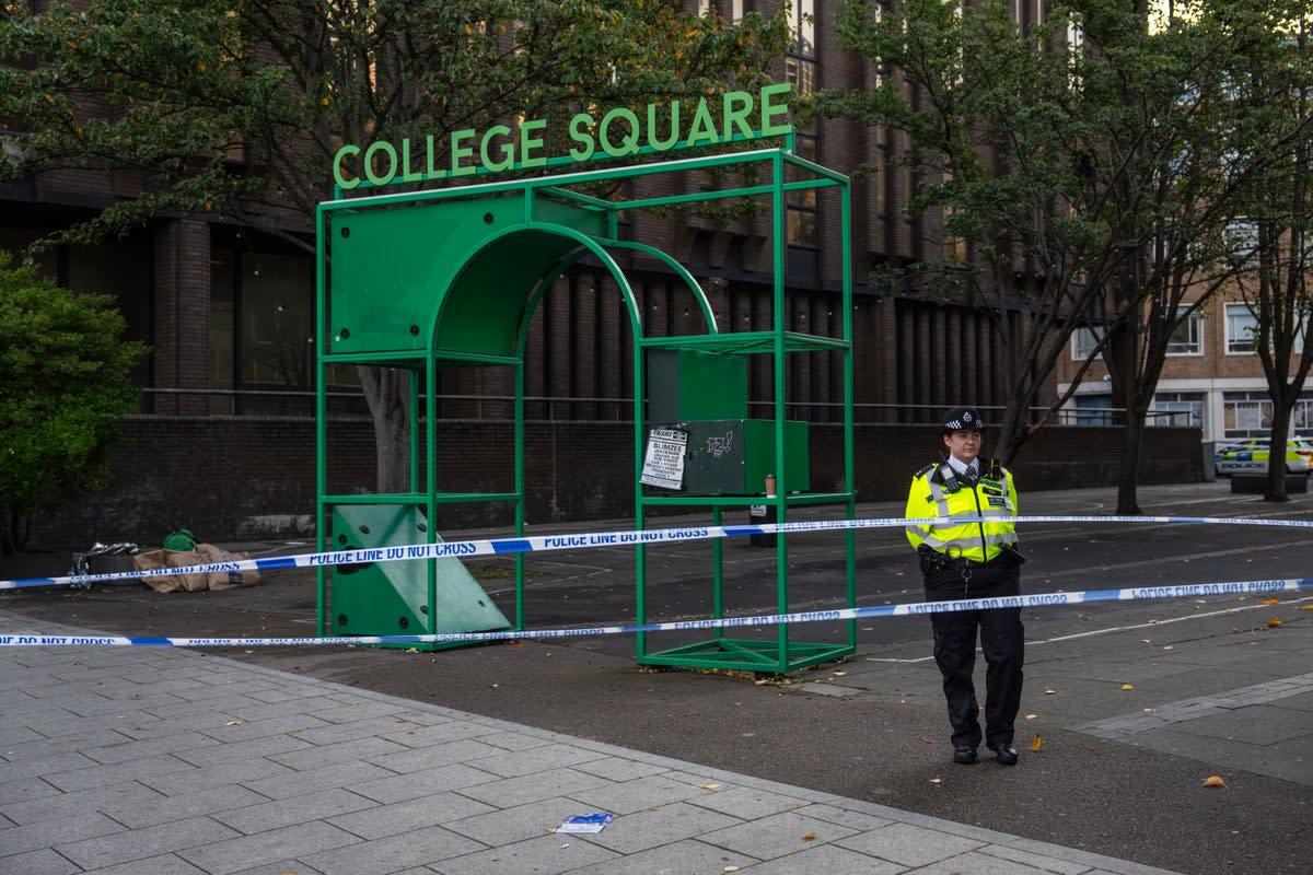 A police officer stands next to a cordon marking off the scene of a stabbing outside Croydon College (Getty Images)