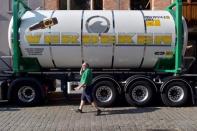 A driver walks near his truck as he collects beer from De Halve Maan brewery in Bruges, Belgium, September 15, 2016. REUTERS/Eric Vidal