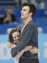 Meagan Duhamel and Eric Radford of Canada celebrate at the end of their performance during the Team Pairs Short Program at the Sochi 2014 Winter Olympics, February 6, 2014. REUTERS/Lucy Nicholson