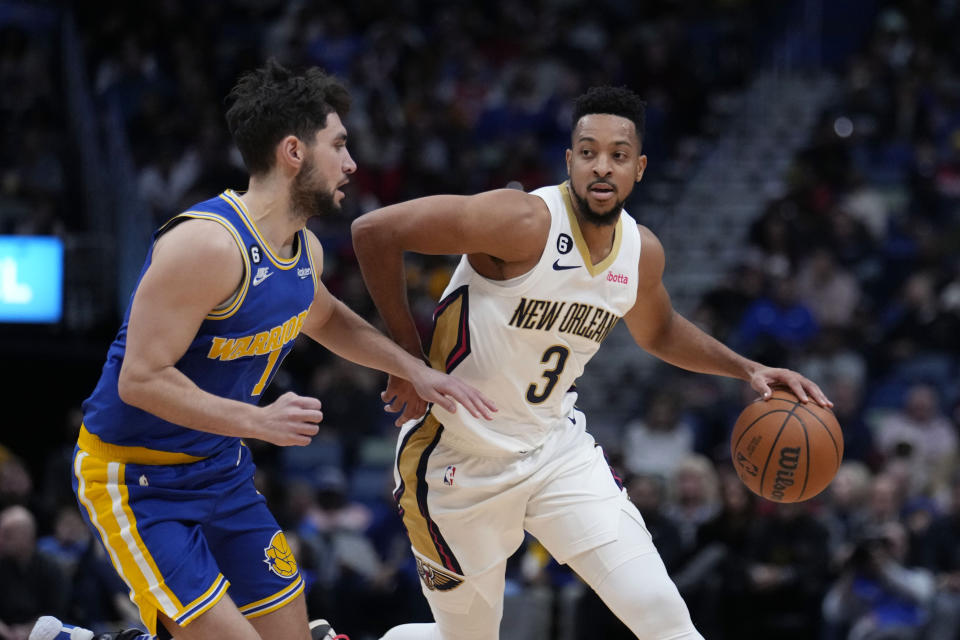 New Orleans Pelicans guard CJ McCollum (3) drives against Golden State Warriors guard Ty Jerome in the first half of an NBA basketball game in New Orleans, Monday, Nov. 21, 2022. (AP Photo/Gerald Herbert)