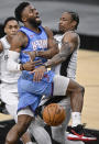 Houston Rockets' David Nwaba, left, is fouled by San Antonio Spurs' DeMar DeRozan during the second half of an NBA basketball game, Saturday, Jan. 16, 2021, in San Antonio. (AP Photo/Darren Abate)