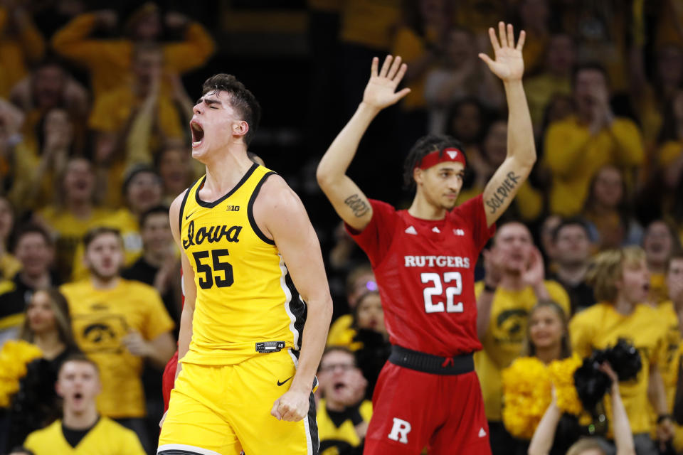 Iowa center Luka Garza celebrates in front of Rutgers guard Caleb McConnell (22) after making a basket during the first half of an NCAA college basketball game, Wednesday, Jan. 22, 2020, in Iowa City, Iowa. (AP Photo/Charlie Neibergall)