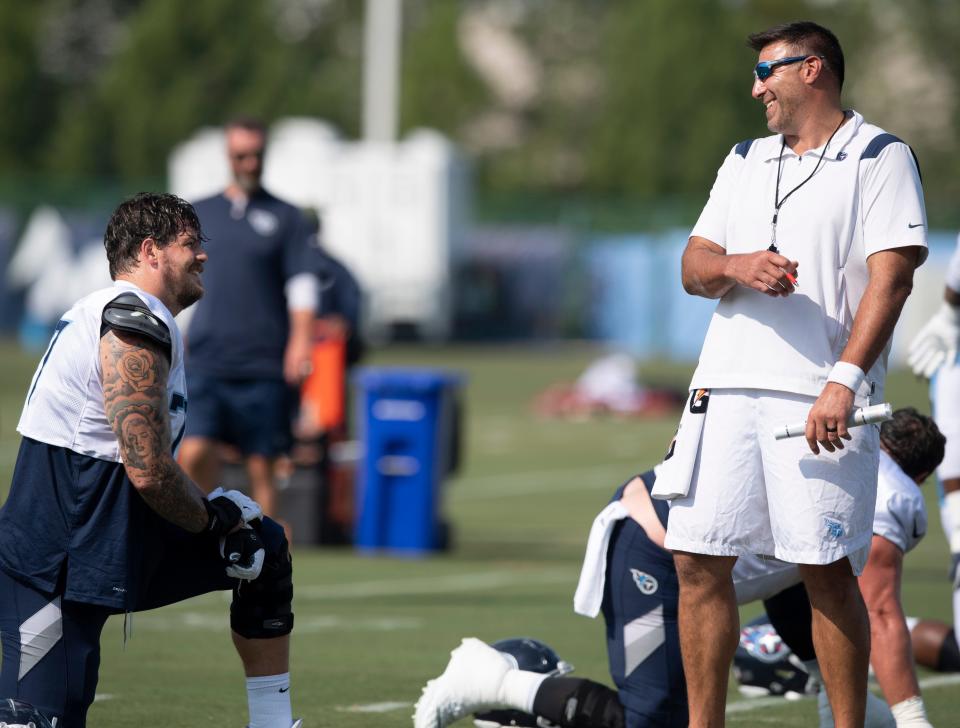 Tennessee Titans tackle Taylor Lewan (77) and head coach Mike Vrabel share a laugh during a training camp practice at Saint Thomas Sports Park Tuesday, Aug. 3, 2021 in Nashville, Tenn. 