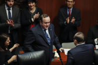 Guatemala's President Alejandro Giammattei, center, is applauded by members of Mexico's Senate after speaking during a senate session in Mexico City, Thursday, Feb. 6, 2020. (AP Photo/Rebecca Blackwell)