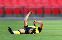 LONDON, ENGLAND - AUGUST 02: A Harrogate Town player holds up his medal as he talks to someone on his phones following the Vanarama National League Play Off Final match between Harrogate Town and Notts County at Wembley Stadium on August 02, 2020 in London, England. (Photo by Catherine Ivill/Getty Images)