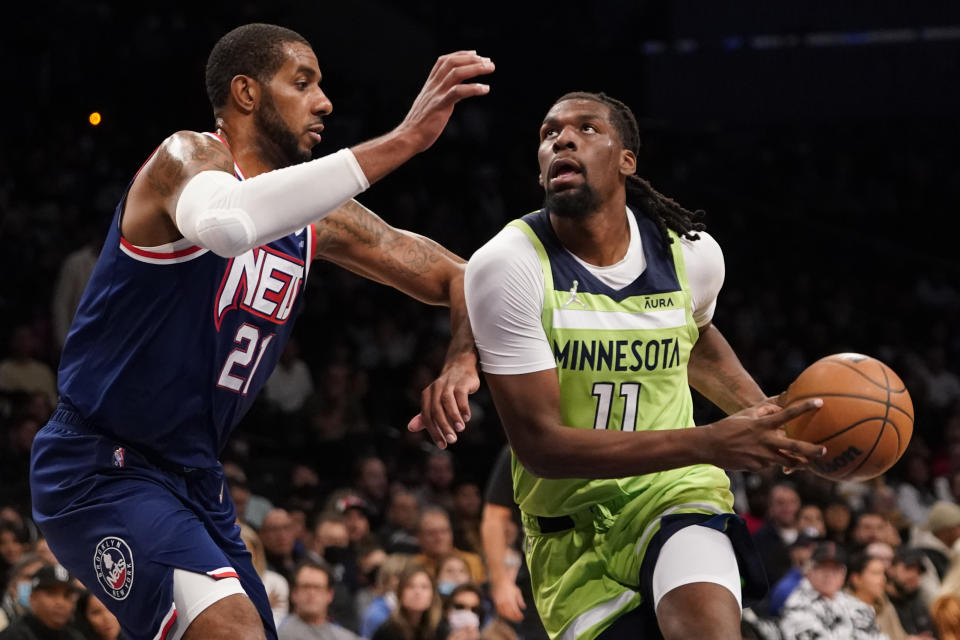 Minnesota Timberwolves center Naz Reid (11) drives against Brooklyn Nets center LaMarcus Aldridge (21) during the first half of an NBA basketball game Friday, Dec. 3, 2021, in New York. (AP Photo/Mary Altaffer)