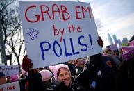 A woman holds a sign as she takes part in the Second Annual Women’s March in Chicago