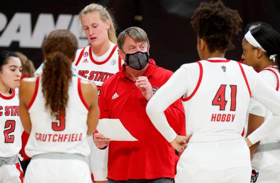 N.C. State head coach Wes Moore talks with his team during the first half of N.C. State’s game against Clemson at Reynolds Coliseum in Raleigh, N.C., Thursday, February 11, 2021.