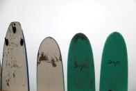 Doyle surfboards rest against a wall at a surf camp in Malibu