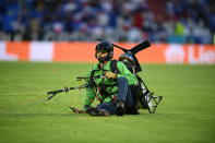 A demonstrator landed on the pitch before the Euro 2020 soccer championship group F match between France and Germany at the Allianz Arena stadium in Munich, Tuesday, June 15, 2021. (Matthias Hangst/Pool via AP)