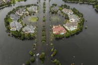 <p>Floodwaters fill the road running through the Lakes On Eldridge North subdivision in the aftermath of Tropical Storm Harvey on Wednesday, Aug. 30, 2017, in Houston, Texas. (Photo: Brett Coomer/Houston Chronicle via AP) </p>