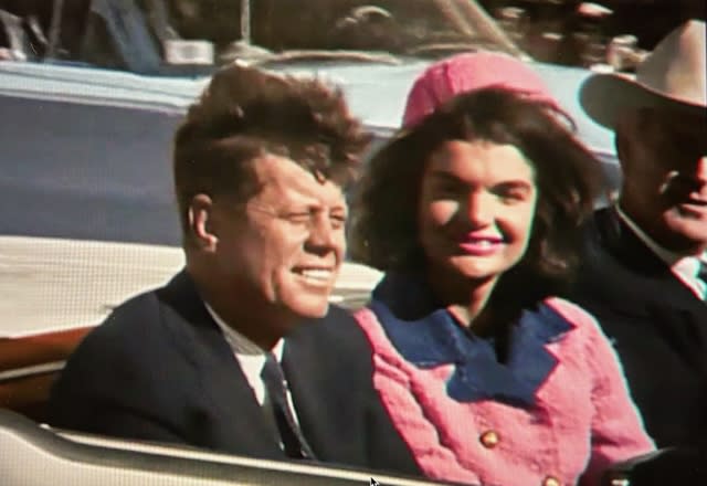 JFK and wife Jackie ride in the open-air limo on the fateful day in Dallas.