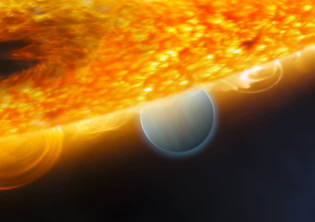 A handout photo from the European Space Agency released December 10, 2008 shows an artist's impression of the Jupiter-size extrasolar planet, HD 189733b, being eclipsed by its parent star. Astronomers using the Hubble Space Telescope have measured carbon dioxide and carbon monoxide in the planet's atmosphere. The planet is a ?hot Jupiter?, so close to its parent star that it completes an orbit in only 2.2 days. This type of observation is best carried out when the planet's orbit takes it behind the star (as seen from Earth), allowing for an opportunity to subtract the light of the star alone (when the planet is hidden behind it) from that of the star and planet together before an eclipse. This allows astronomers to isolate the infrared emission of the planet and carry out spectroscopic observations that chemically analyse the dayside atmosphere. REUTERS/ESA/NASA/M. Kornmesser (ESA/Hubble)/STScI.