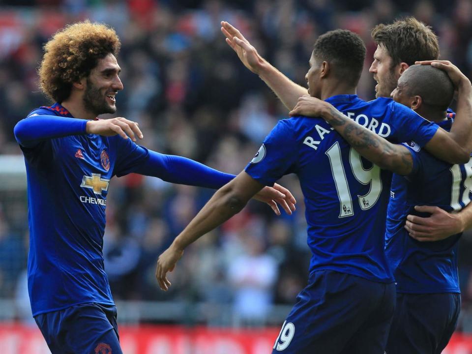 Fellaini celebrates with teammates after scoring the opening goal (Getty)