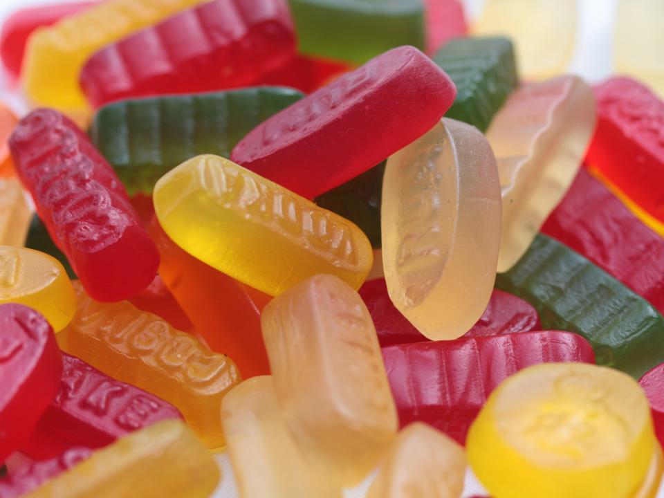 White, yellow, red, and green wine gums in a pile
