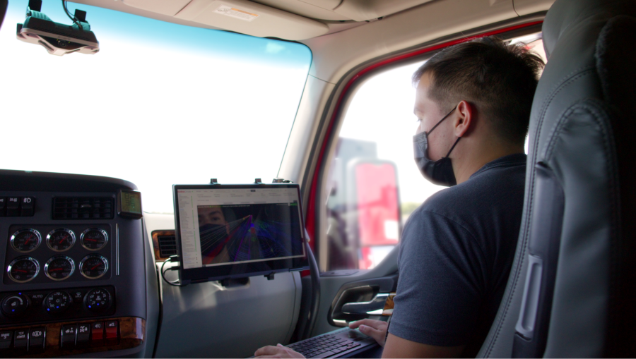 A Kodiak Robotics employee in the passenger seat of a self-driving 18-wheeler monitors the technology on a computer (Courtesy: Kodiak Robotics)