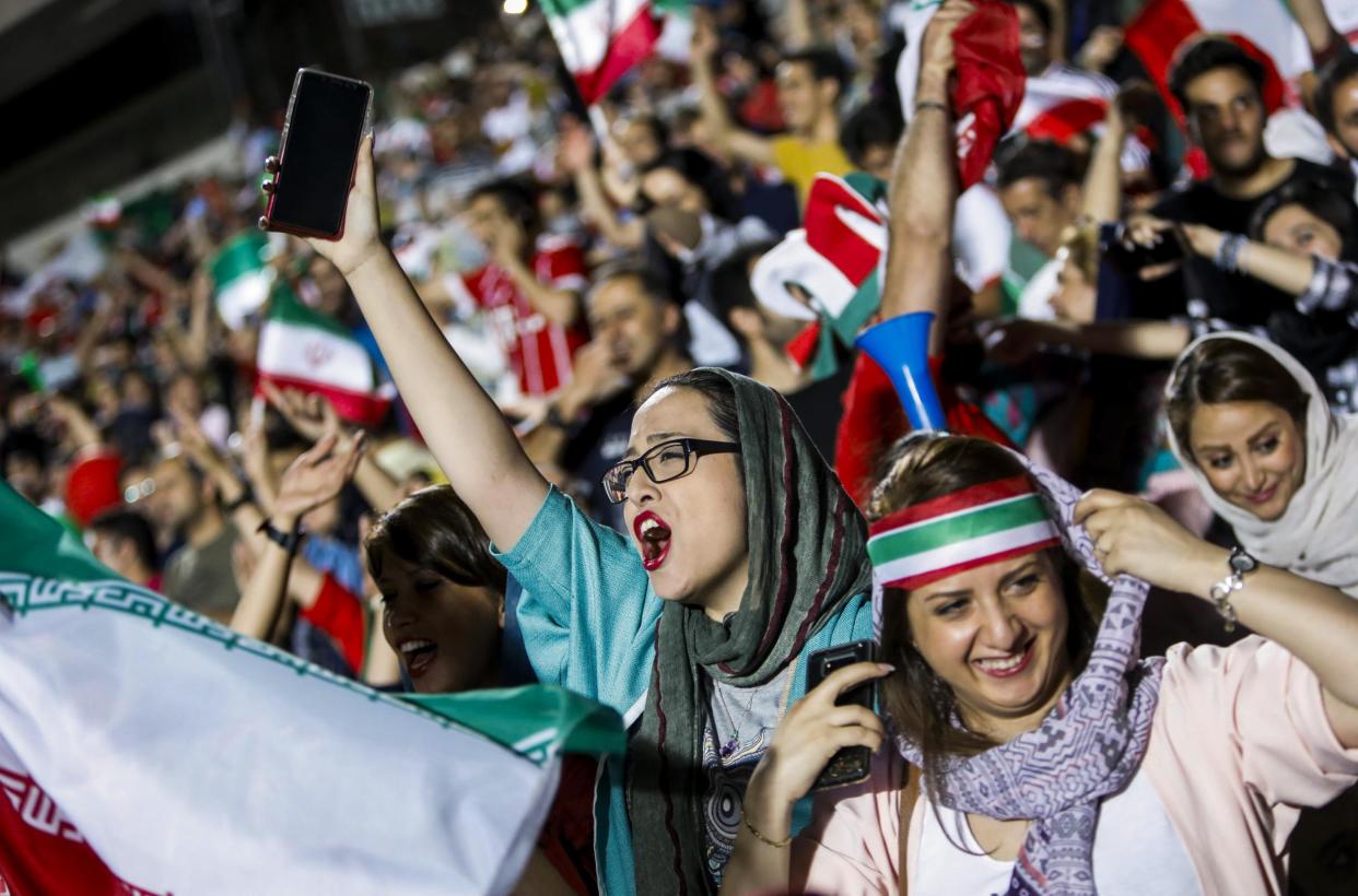 Women cheer on the Iranian national team during their Group B match against Sp: AFP/Getty Images