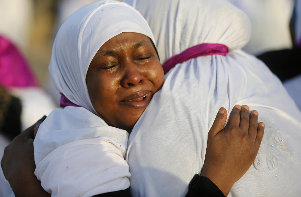 Sudanese pilgrims embrace as they congratulate each other for performing the annual hajj pilgrimage near the Mountain of Mercy, on the Plain of Arafat, near the holy city of Mecca, Saudi Arabia, Saturday, Aug. 10, 2019. More than 2 million pilgrims were gathered to perform initial rites of the hajj, an Islamic pilgrimage that takes the faithful along a path traversed by the Prophet Muhammad some 1,400 years ago. (AP Photo/Amr Nabil)