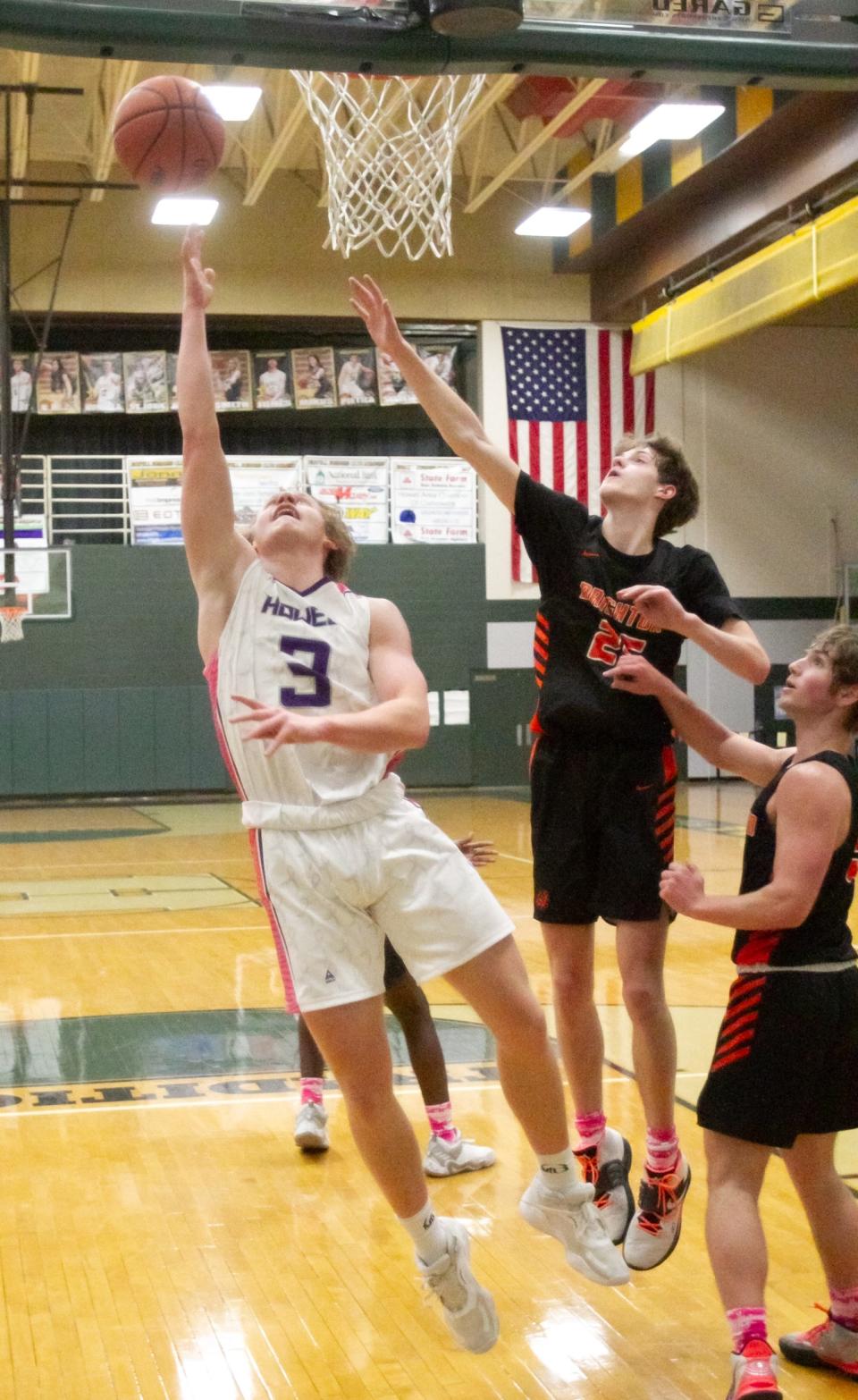 Howell's Beau Eckerle makes a layup while defended by Brighton's Eddie Millington on Friday, Jan. 21, 2022.