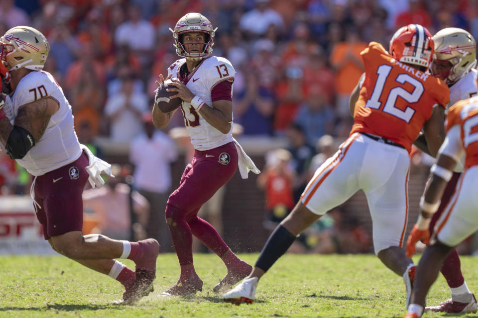 Florida State quarterback Jordan Travis looks to pass during the second half of an NCAA college football game against Clemson, Saturday, Sept. 23, 2023, in Clemson, S.C. (AP Photo/Jacob Kupferman)