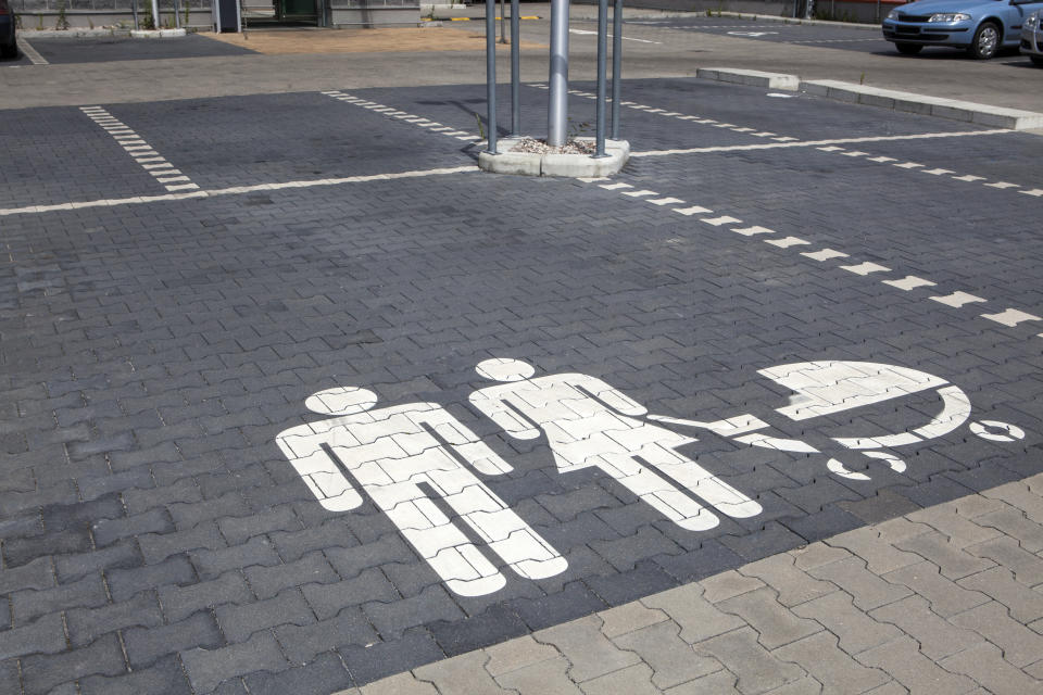 Family parking space with graphic of man, woman and a pram