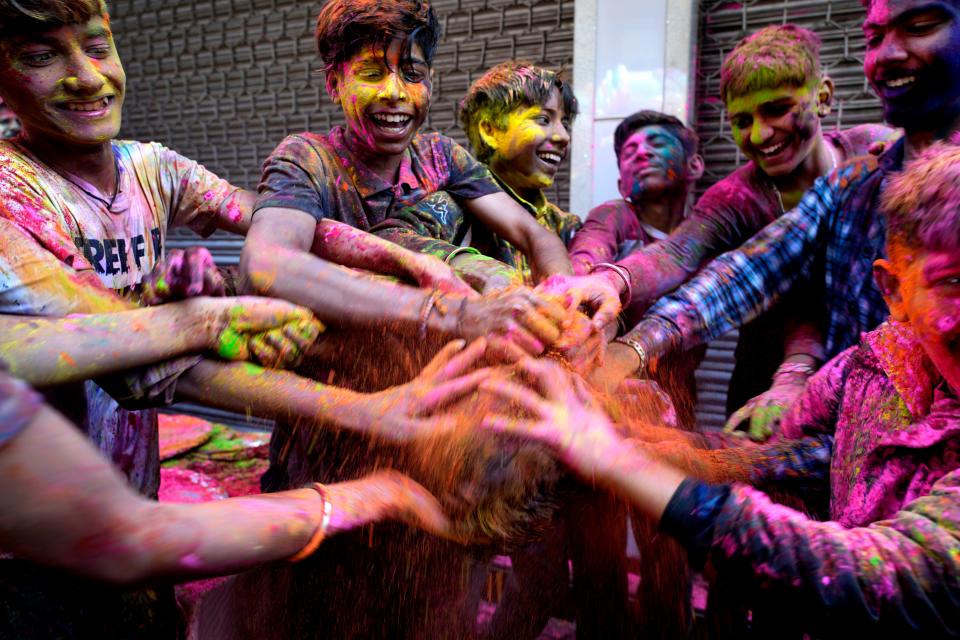 Children put colors on each other as they celebrate Holi, the Hindu festival of colors, in Jammu, India, Tuesday, March 7, 2023.